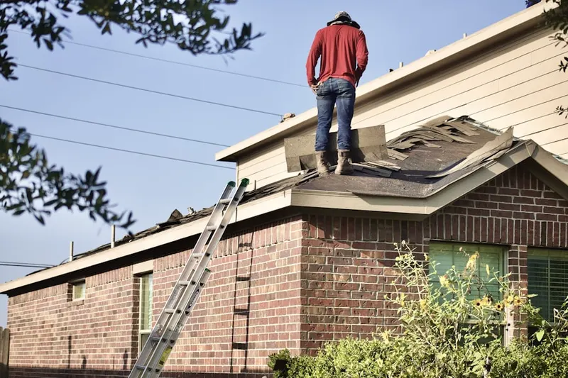 Professional roofer working on a residential roof in Linda
